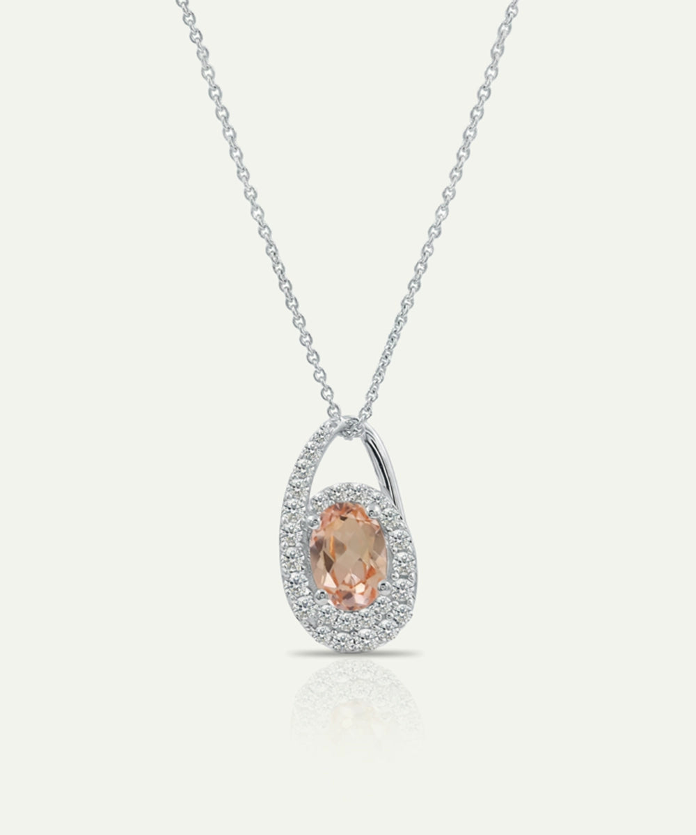 Silver necklace with a pendant featuring a peach-colored gemstone on a white background