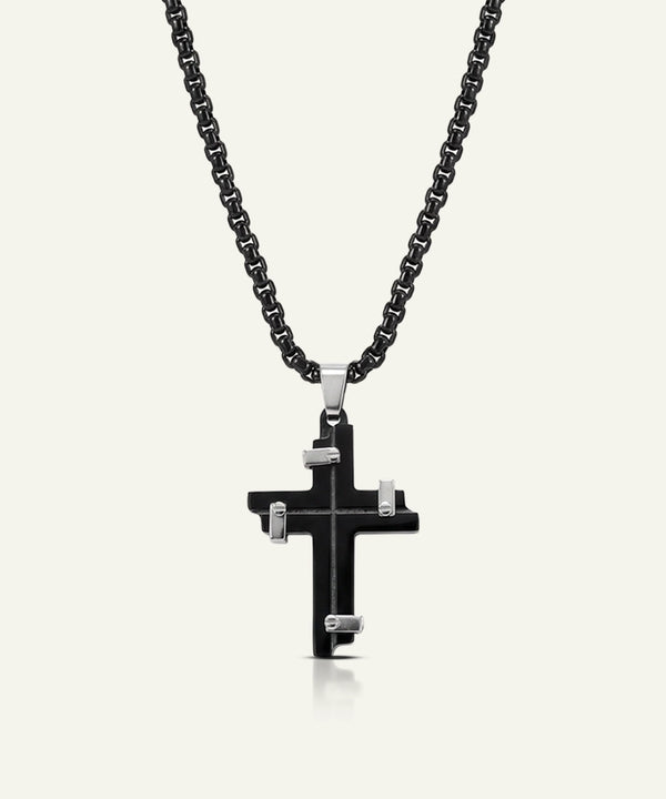 Black cross pendant necklace on a white background