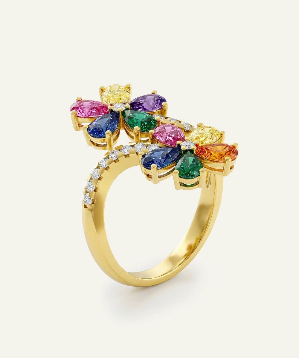 Gold ring with colorful gemstones on a white background