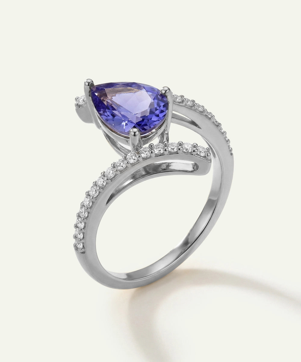 Silver ring with a purple gemstone on a white background