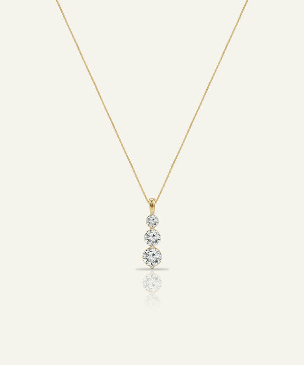 Gold necklace with a diamond pendant on a white background