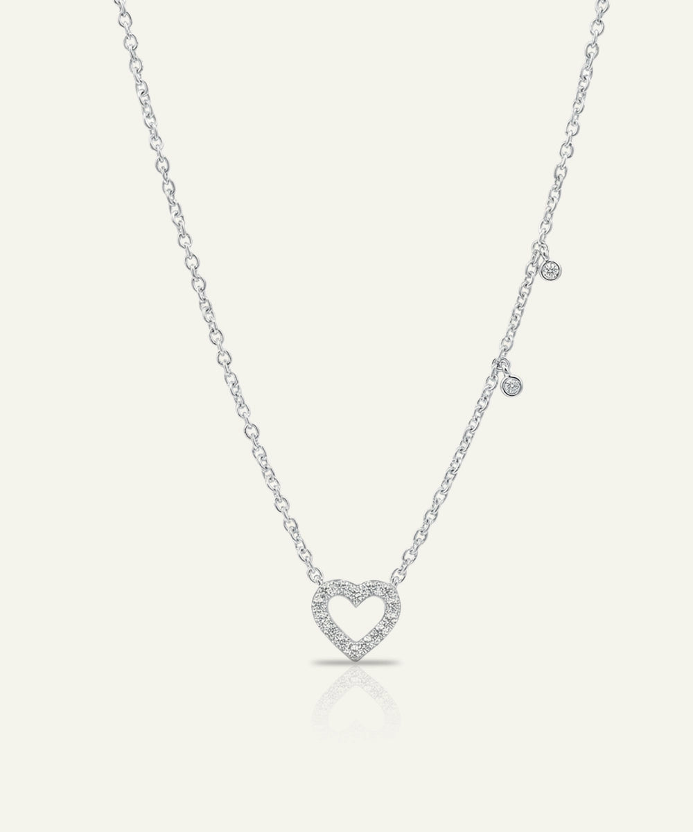 Silver heart-shaped pendant necklace on a white background