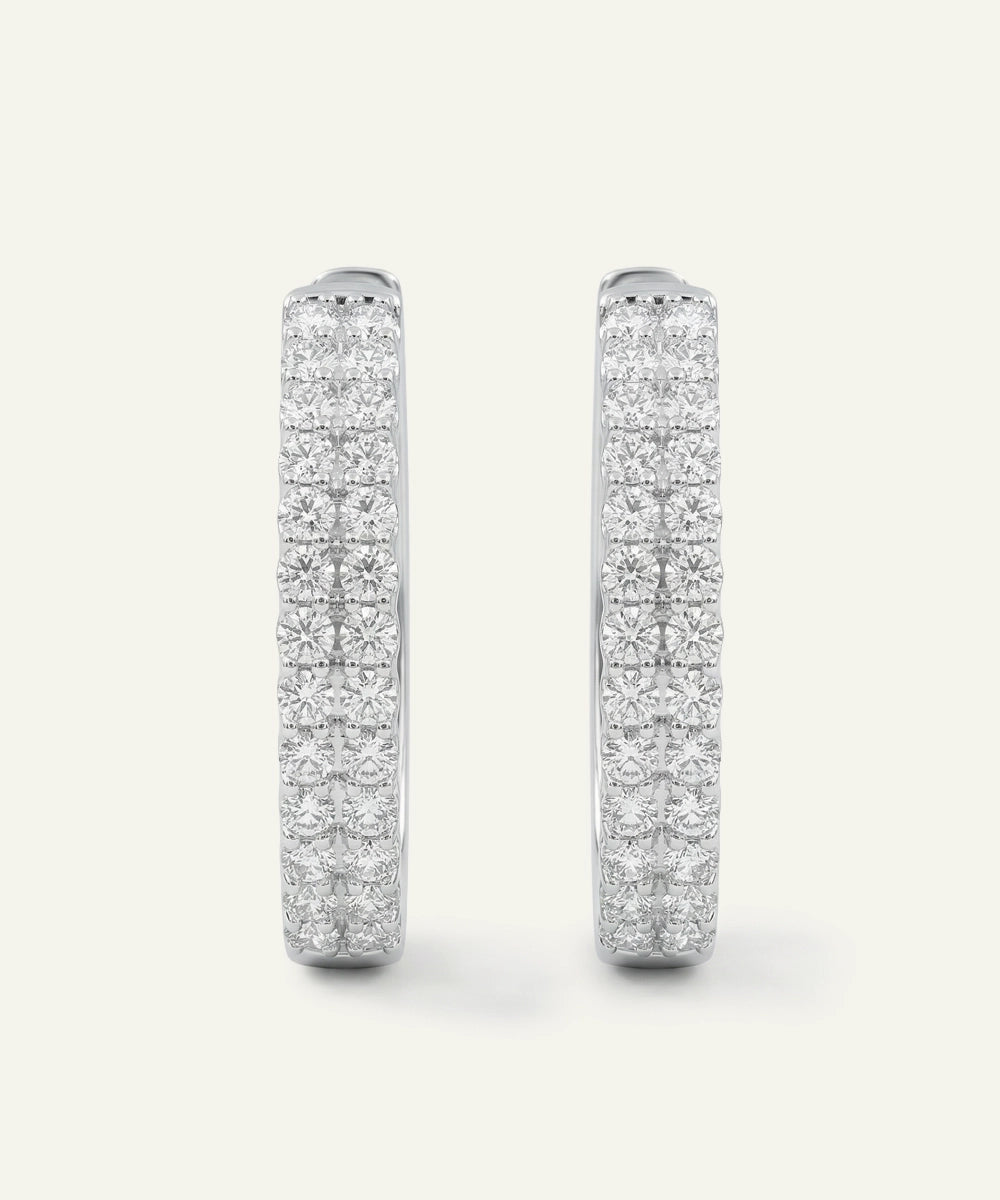 Pair of diamond earrings on a white background