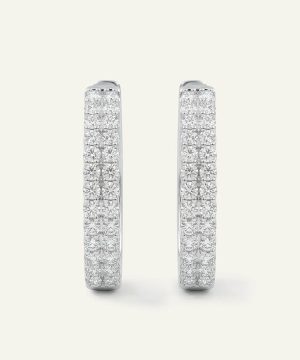 Pair of diamond earrings on a white background