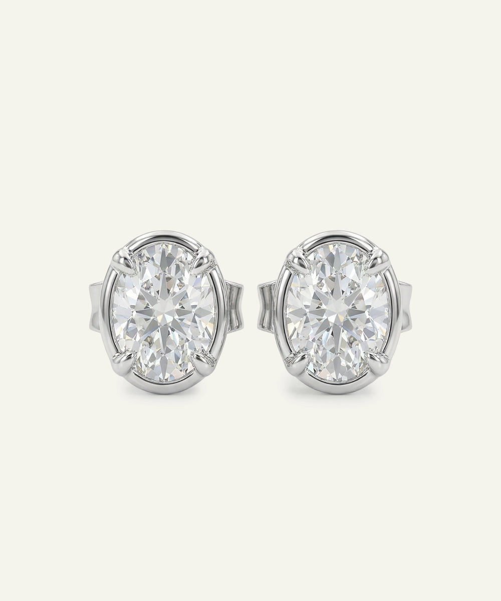 Pair of diamond stud earrings on a light gray background