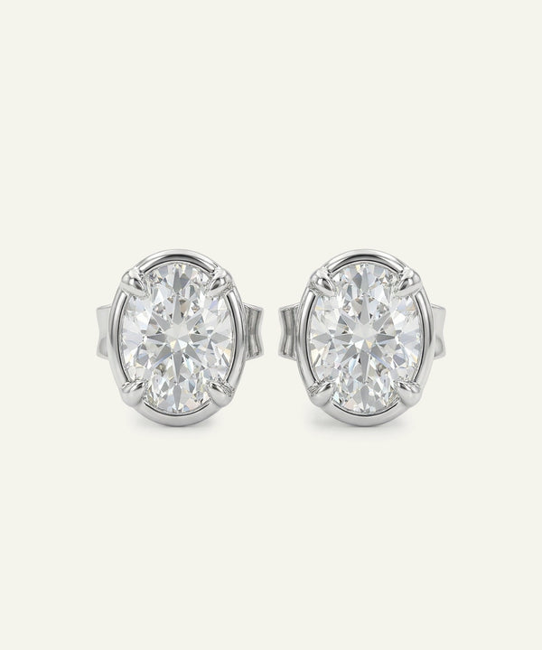 Pair of diamond stud earrings on a light gray background