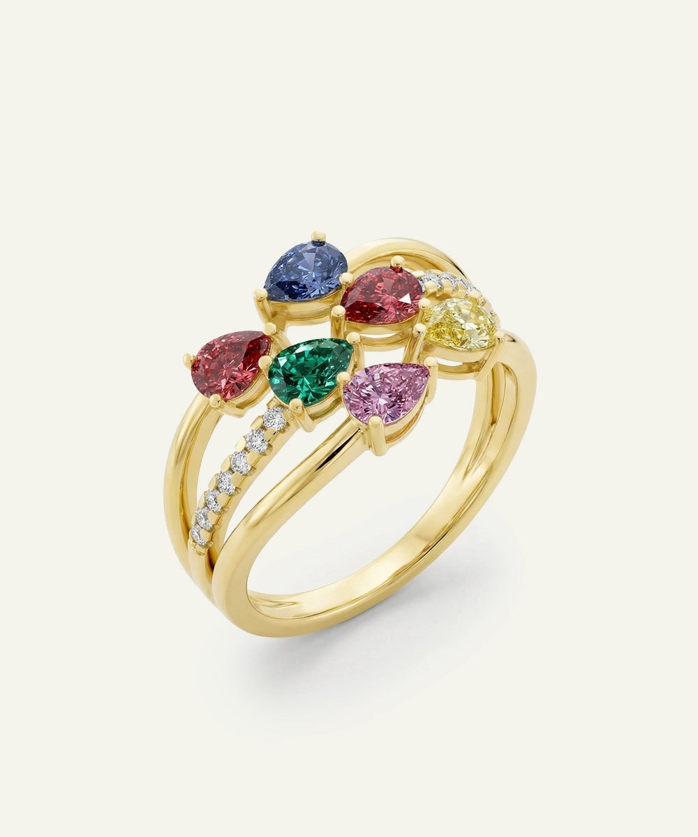 Gold ring with multicolored gemstones on a light gray background