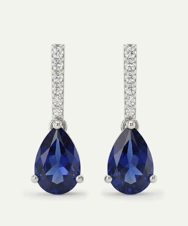 Pair of blue teardrop earrings with silver accents on a white background
