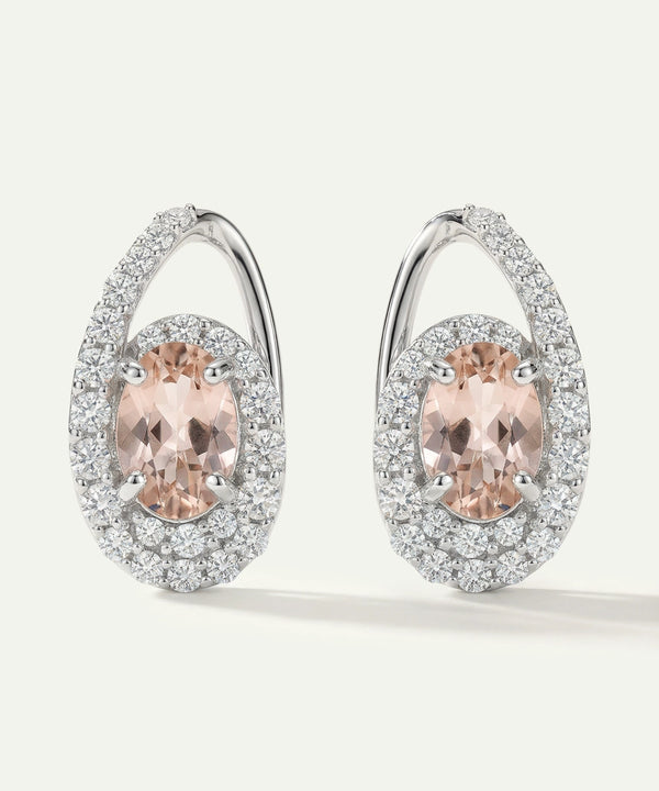 Pair of earrings with pink gemstones and diamond accents on a white background