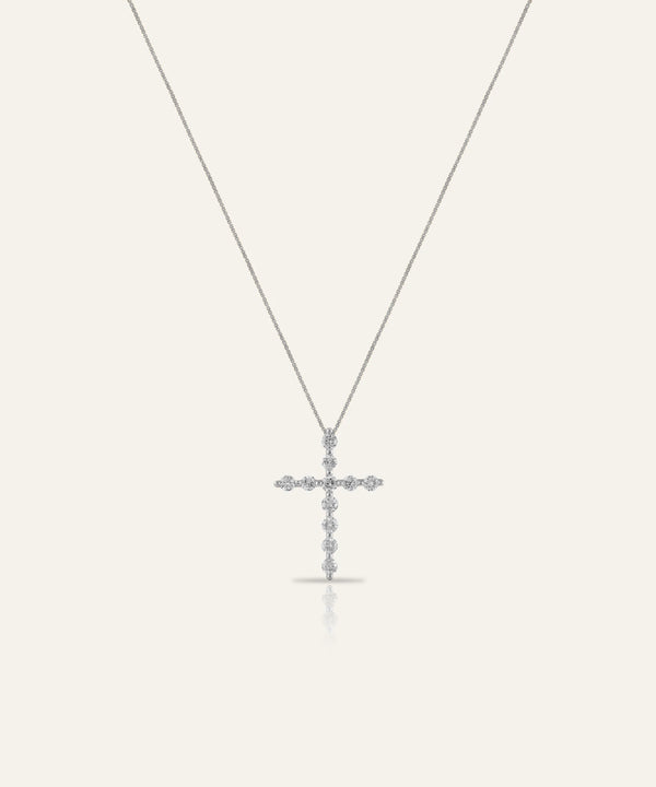Silver cross pendant necklace on a white background