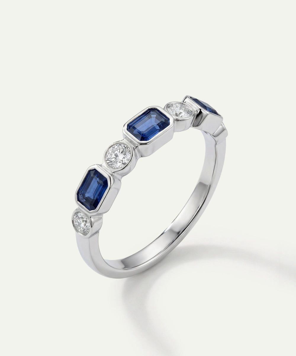 Silver ring with blue gemstones on a white background
