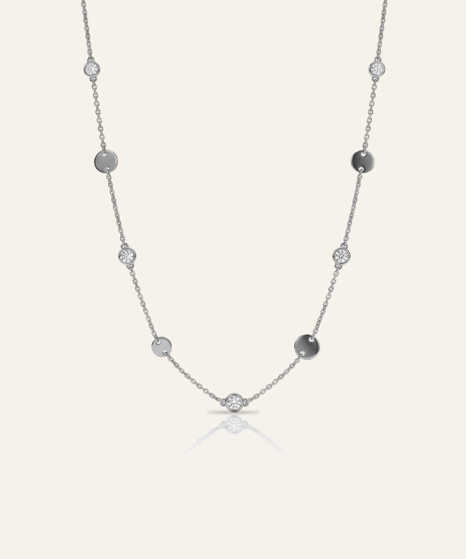 Silver necklace with beads on a light gray background