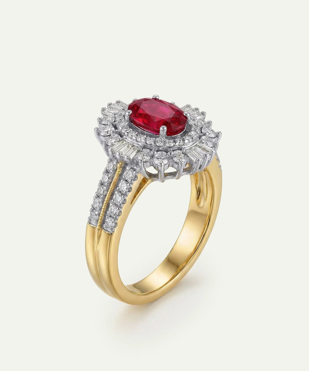 Gold ring with a red gemstone and diamond accents on a white background