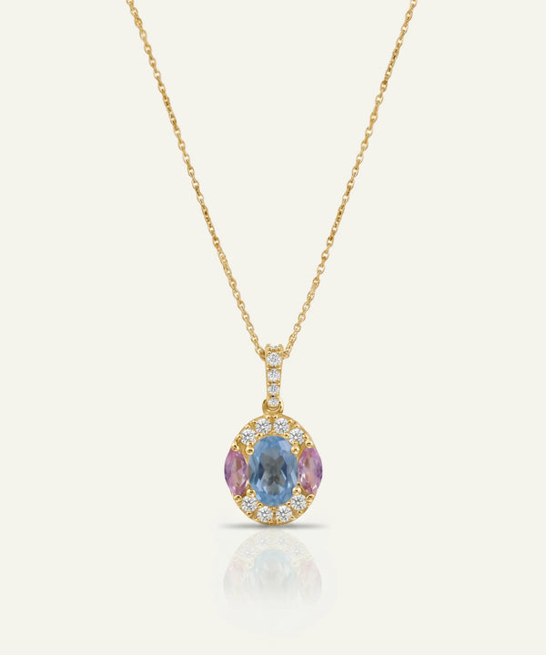 Gold necklace with a multicolored gemstone pendant on a white background