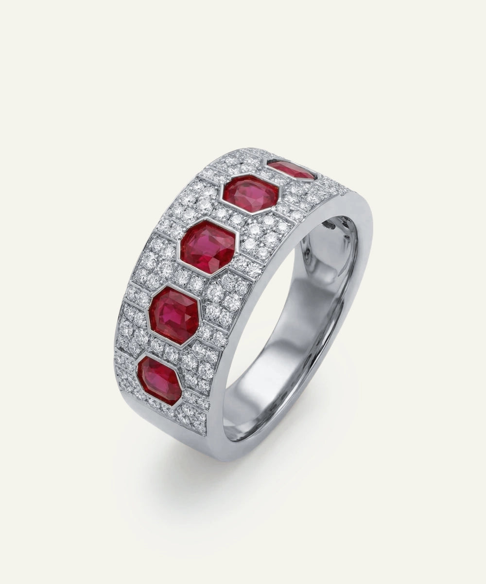 Silver ring with red gemstones on a white background