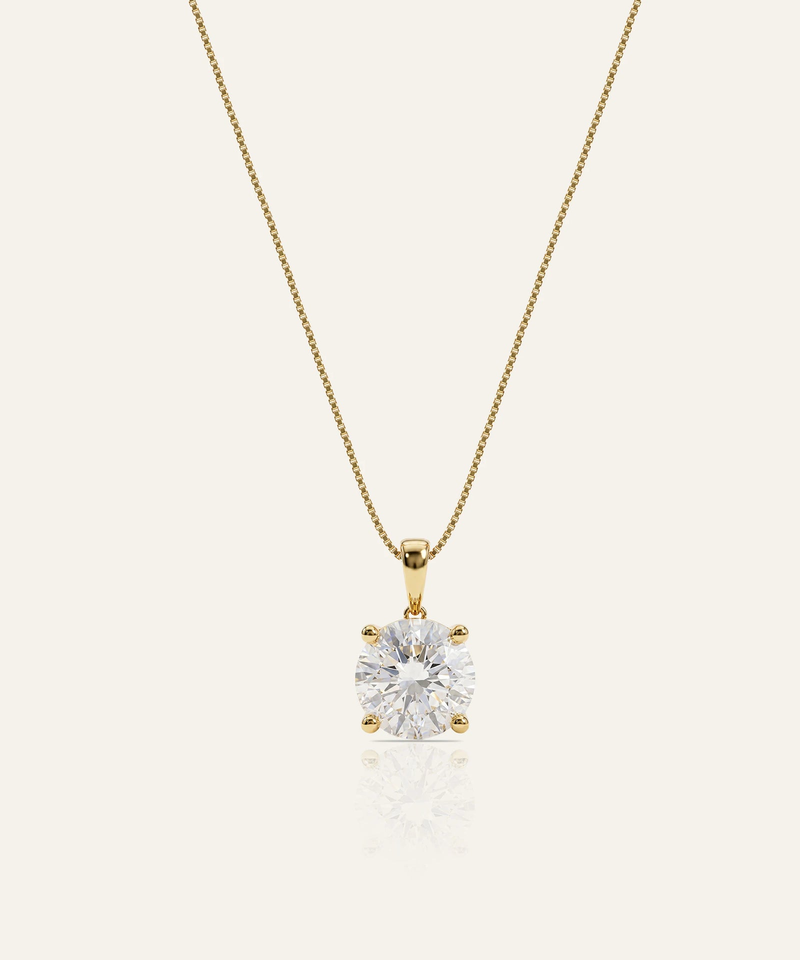 Gold necklace with a diamond pendant on a white background