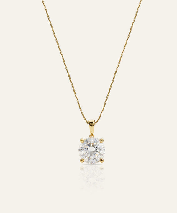 Gold necklace with a diamond pendant on a white background