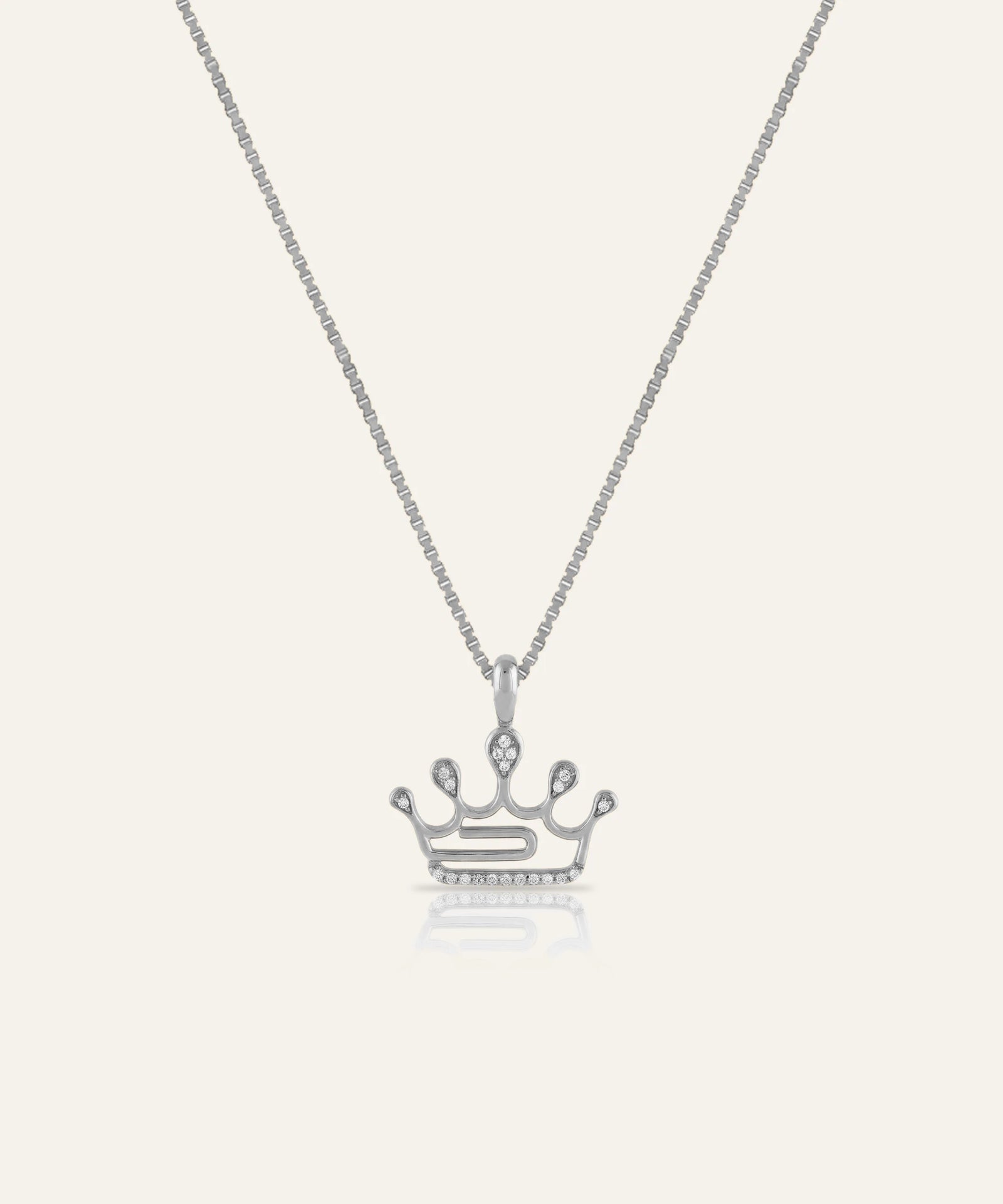 Silver crown pendant necklace on a white background