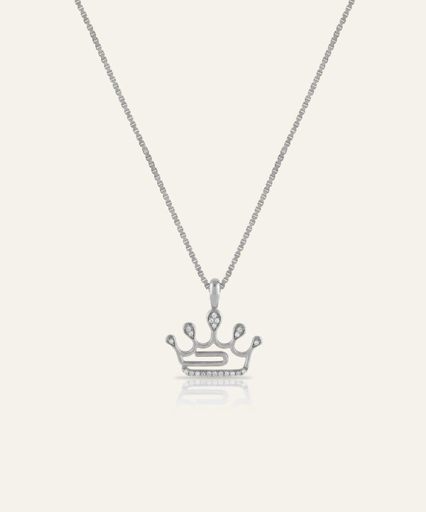 Silver crown pendant necklace on a white background