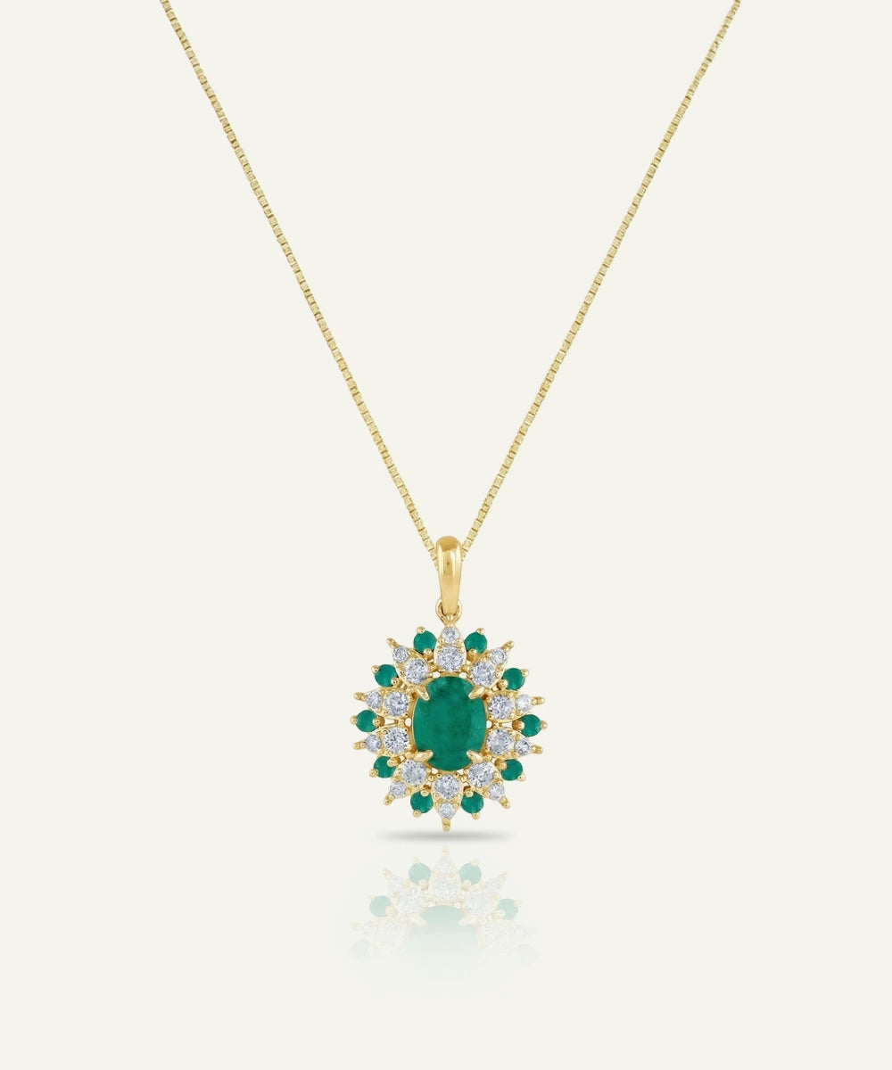 Gold necklace with a green gemstone pendant on a white background