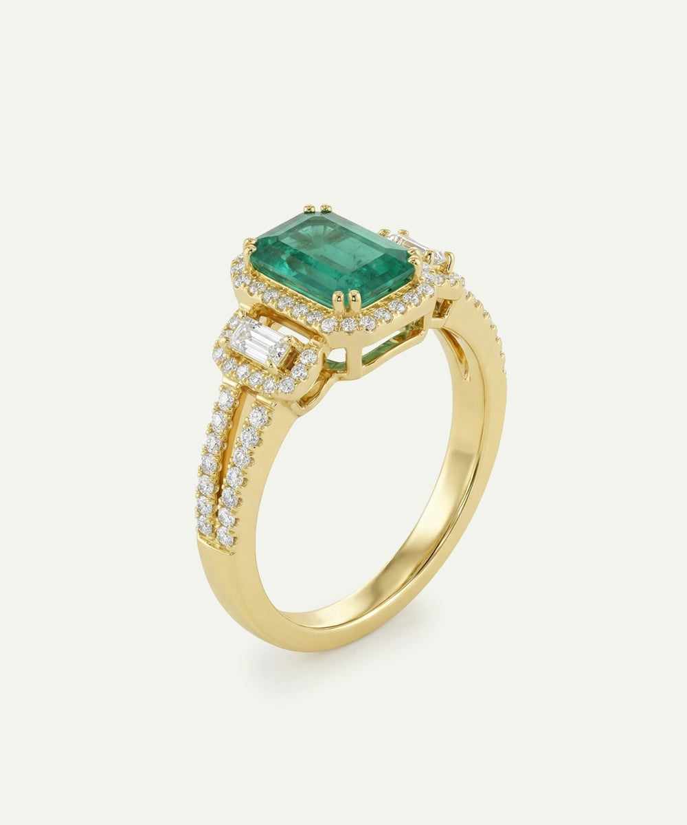Gold ring with a green gemstone and diamond accents on a white background