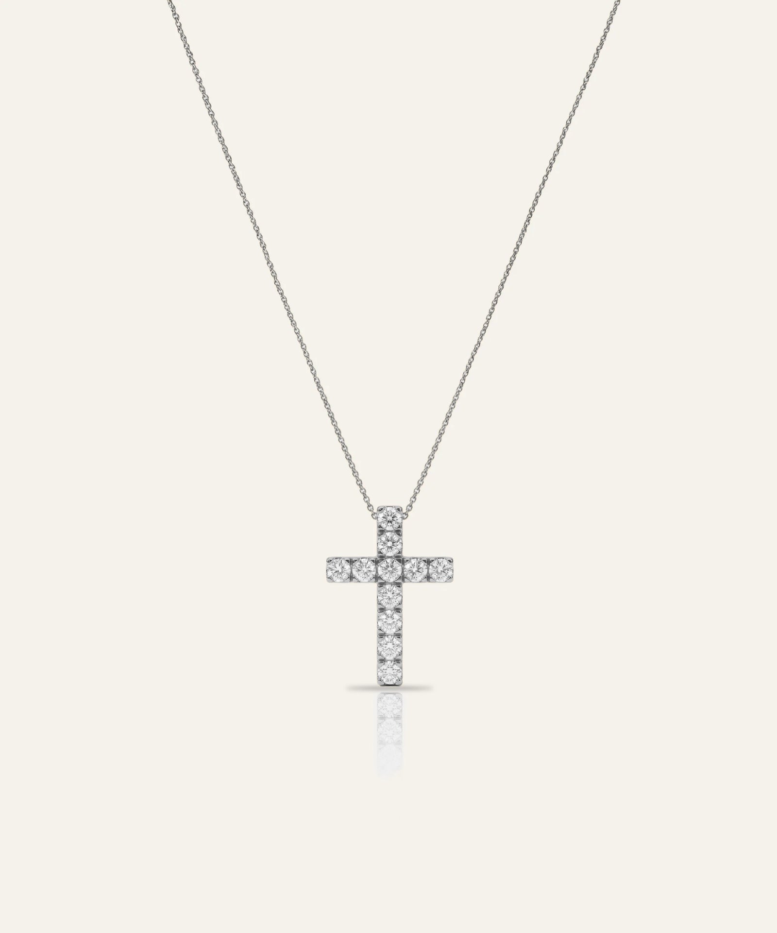 Cross-shaped pendant necklace on a white background