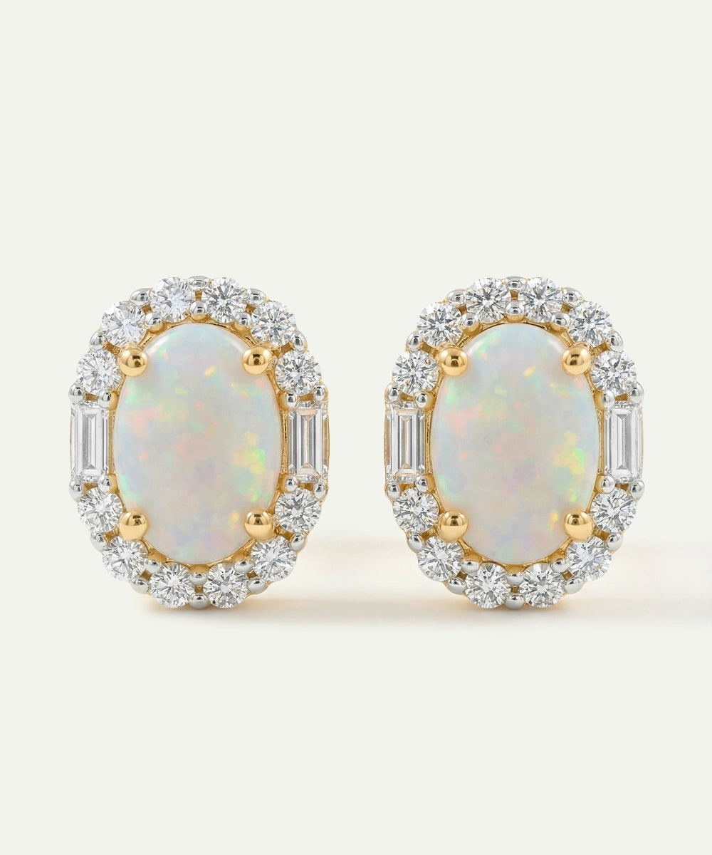 Pair of opal earrings with gold and diamond accents on a light background