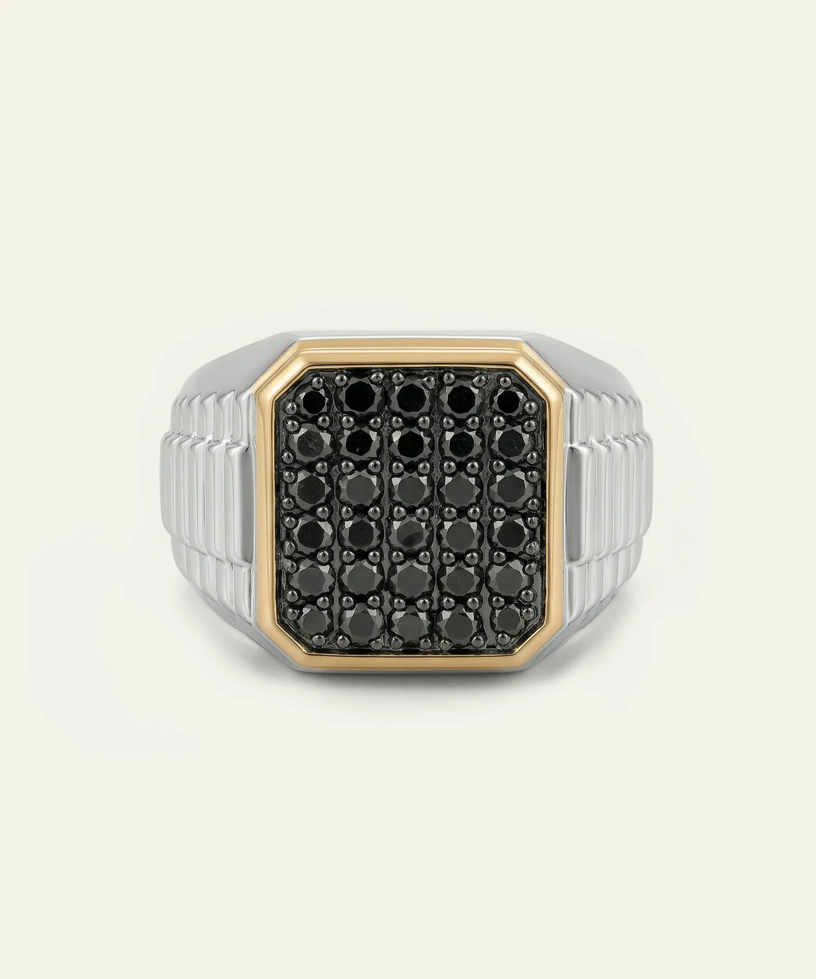 Silver ring with black gemstones on a white background