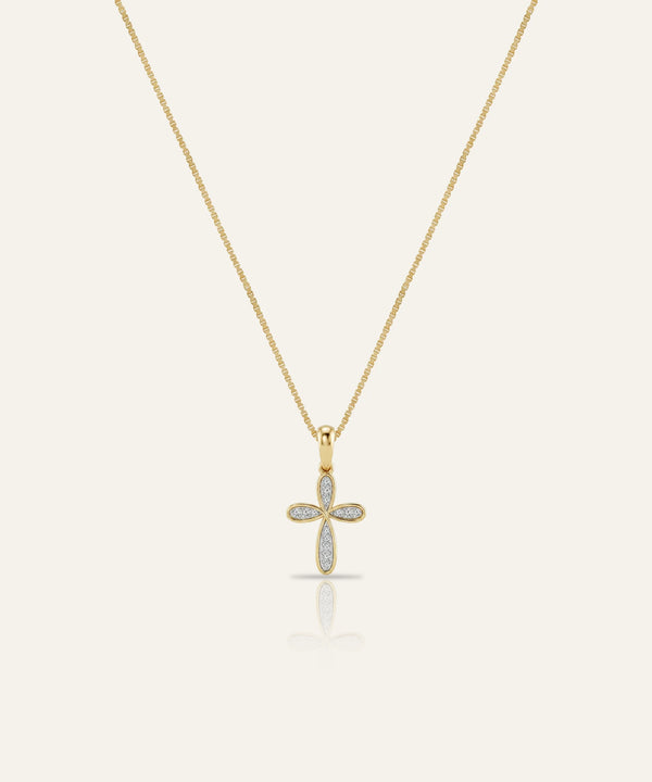 Gold cross necklace with diamonds on a white background