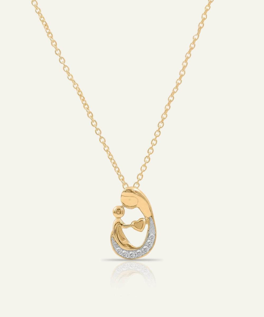 Gold necklace with a heart-shaped pendant on a white background