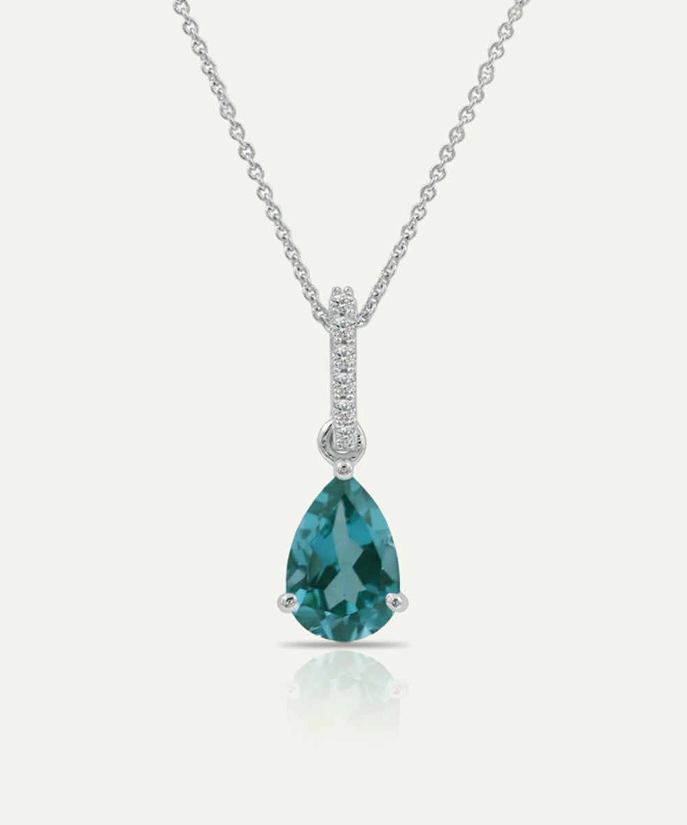 Teardrop-shaped blue gemstone necklace with chain on a white background