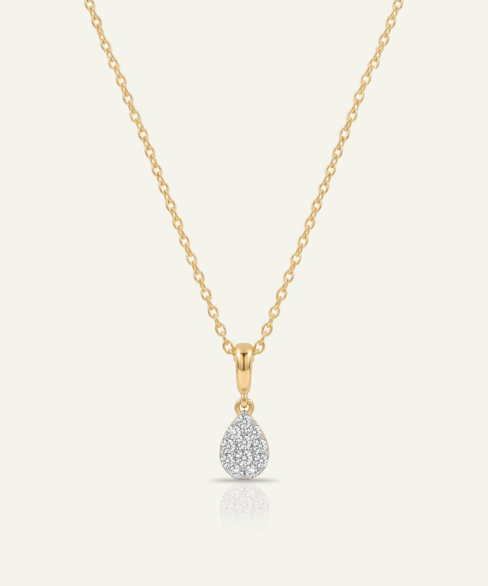 Gold necklace with a teardrop-shaped diamond pendant on a white background