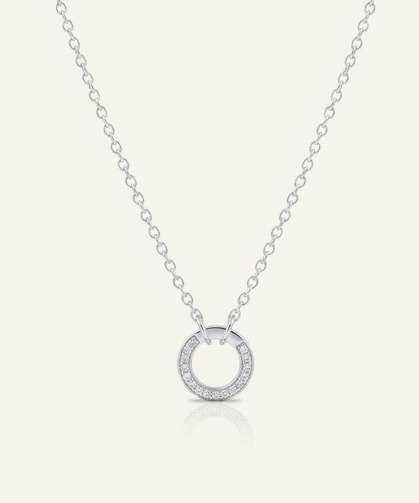 Silver necklace with a circular pendant on a white background