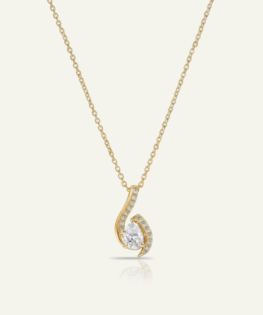 Gold necklace with a delicate pendant on a white background
