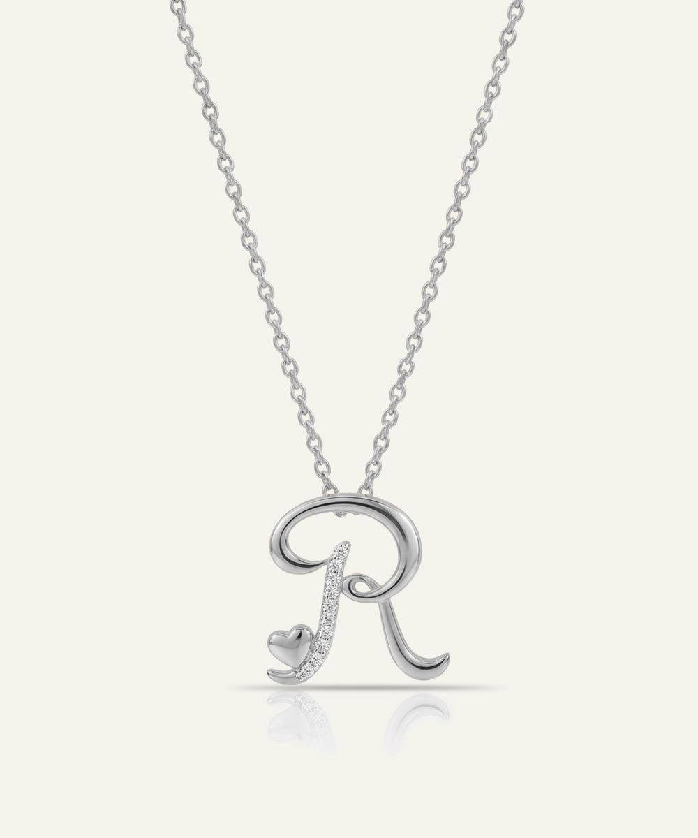 Silver necklace with a letter 'R' pendant on a white background