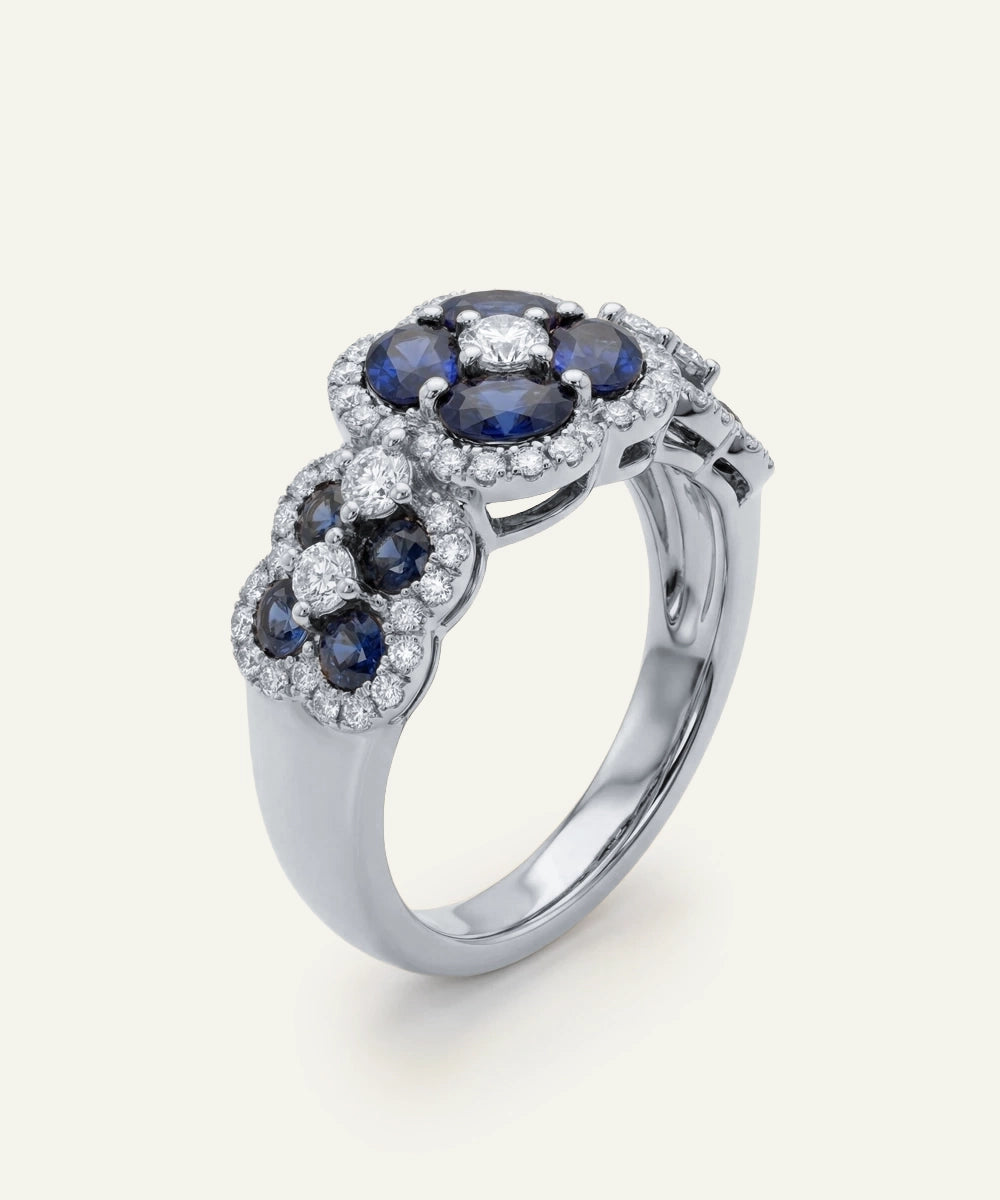 Silver ring with blue gemstones on a white background