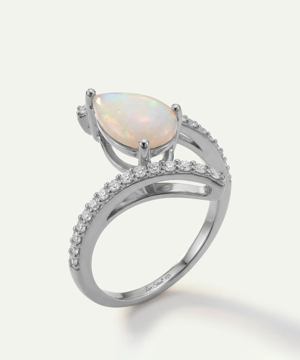 Silver ring with a pear-shaped opal stone on a white background