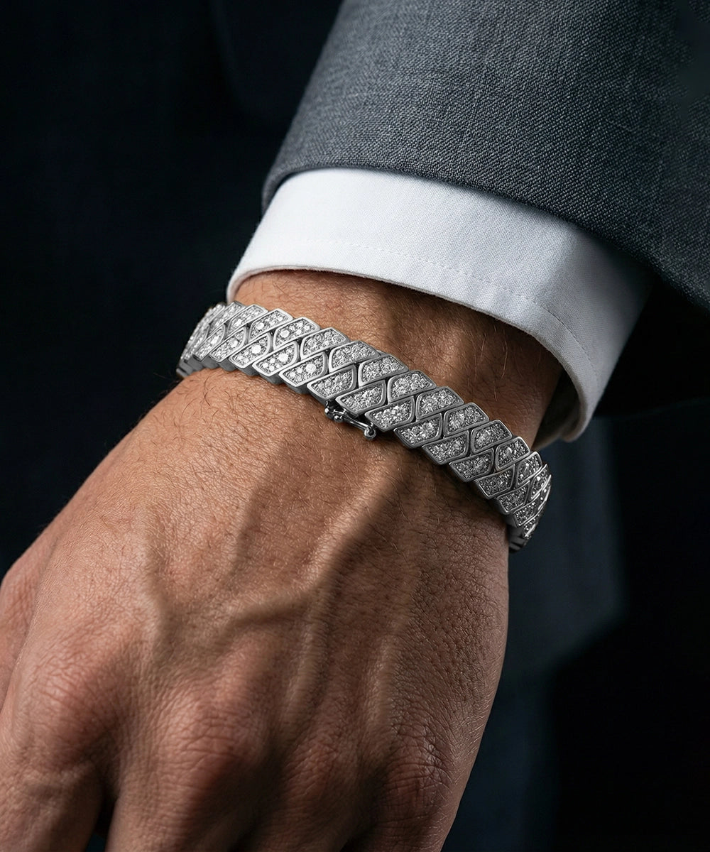 Silver bracelet on a wrist with a dark suit background