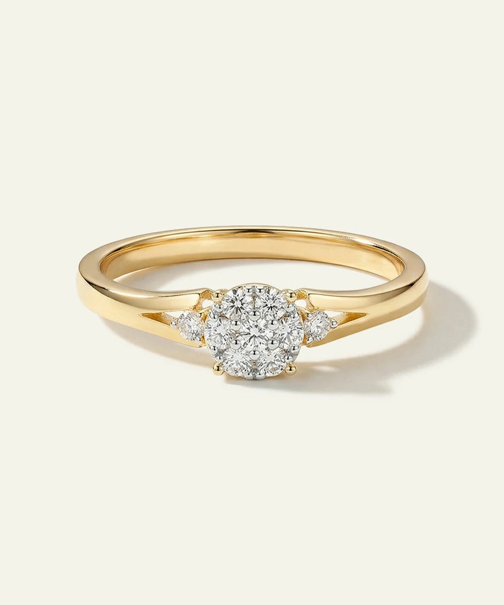 Gold ring with a diamond on a light gray background