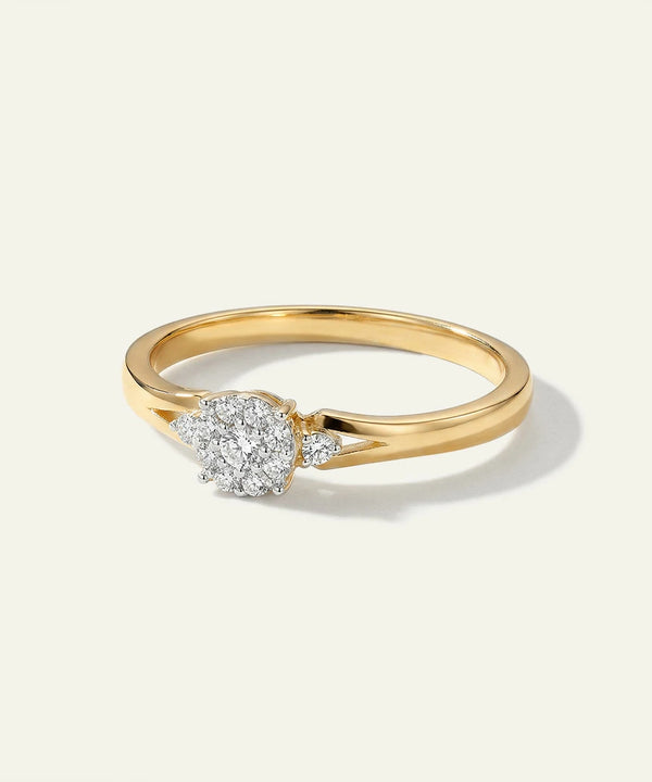 Gold ring with a diamond on a light beige background