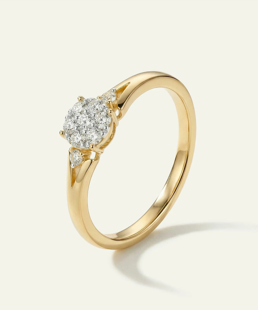 Gold ring with a heart-shaped diamond on a light background