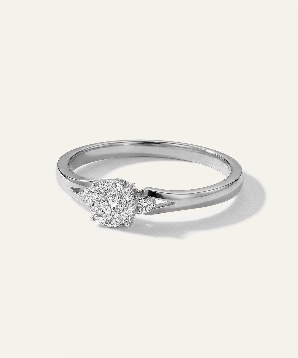 Silver ring with a diamond on a light gray background