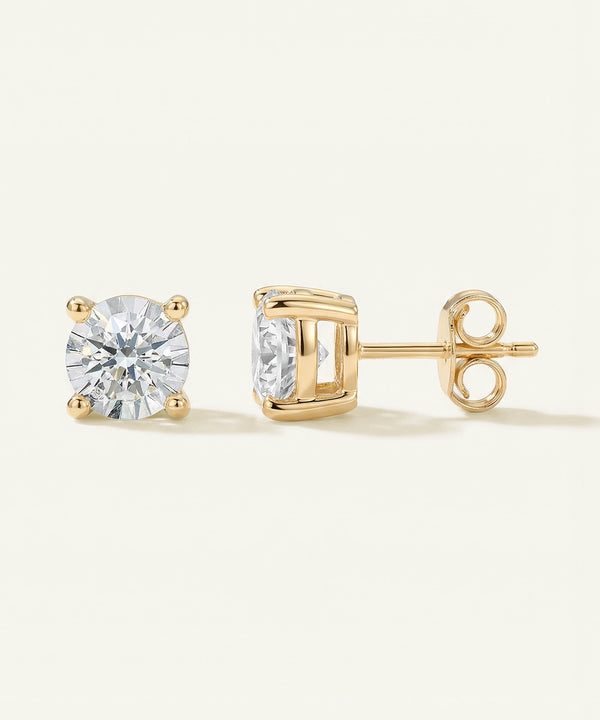 Gold stud earrings with clear gemstones on a white background
