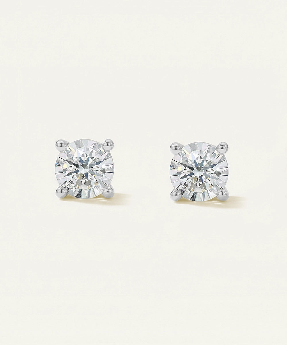 Pair of diamond stud earrings on a light gray background