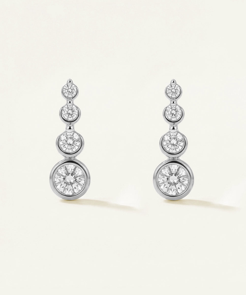 Pair of diamond earrings on a light background