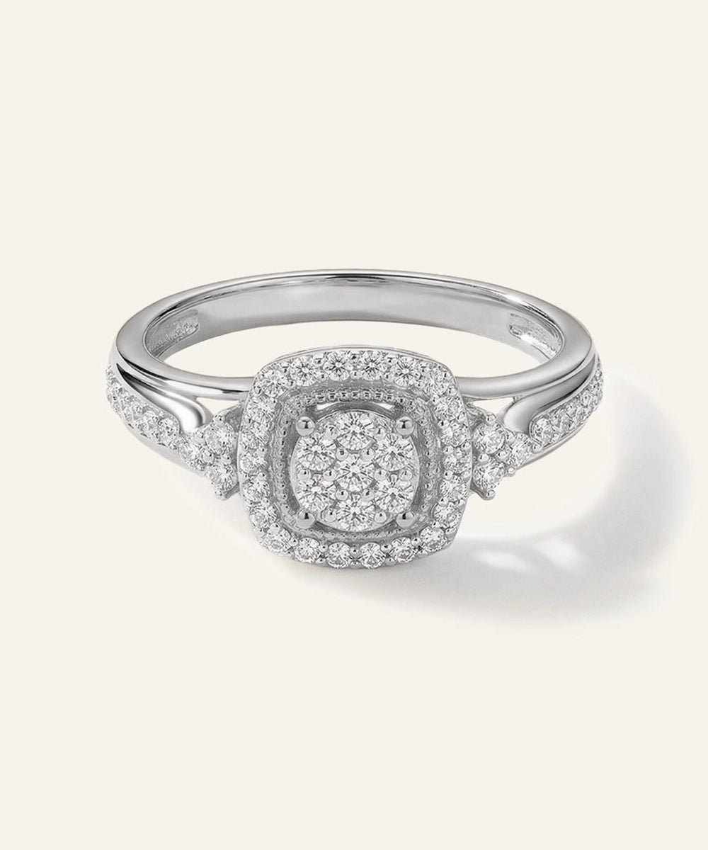Silver ring with diamond accents on a white background