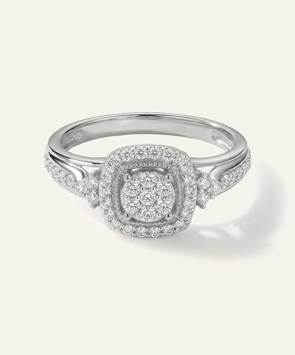 Silver ring with diamond accents on a white background