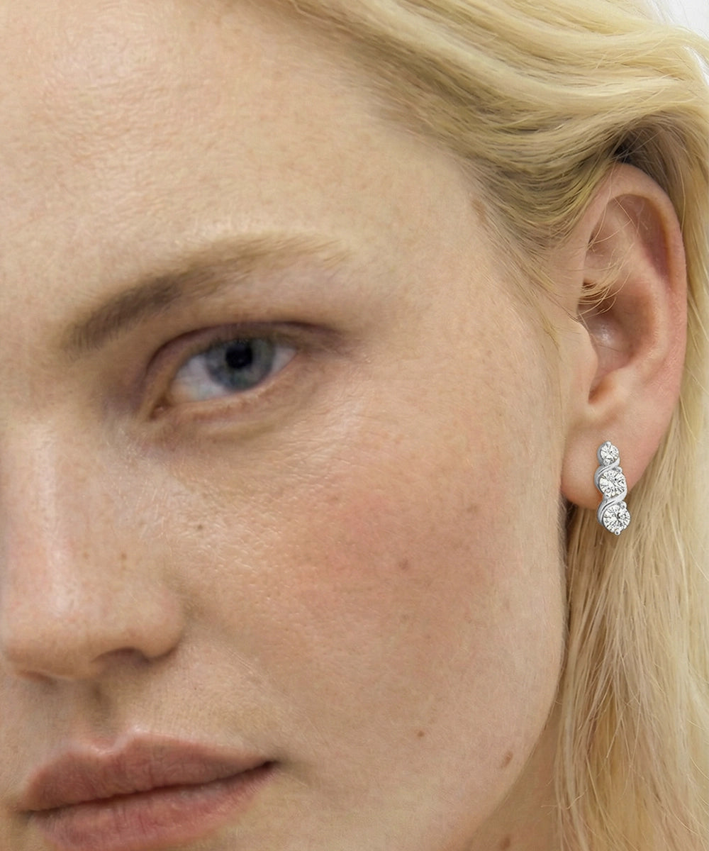 Close-up of a woman wearing a diamond earring.