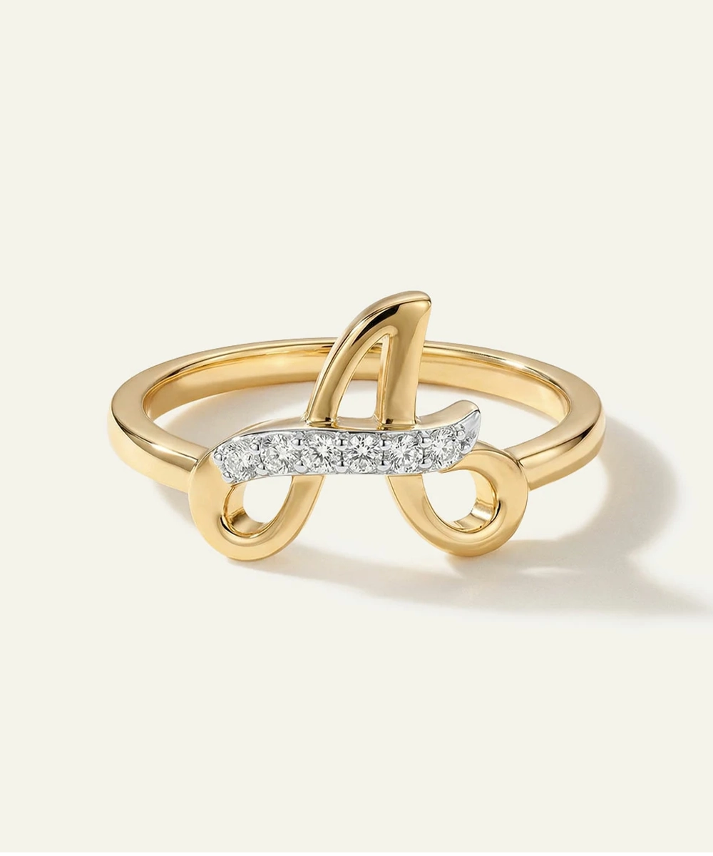 Gold ring with a diamond-studded design on a white background
