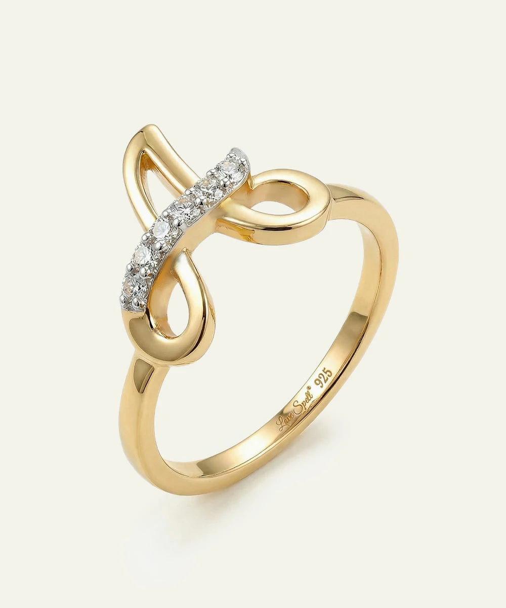 Gold ring with diamond accents on a white background